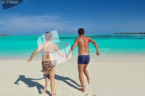 Image of happy young  couple enjoying summer on beach