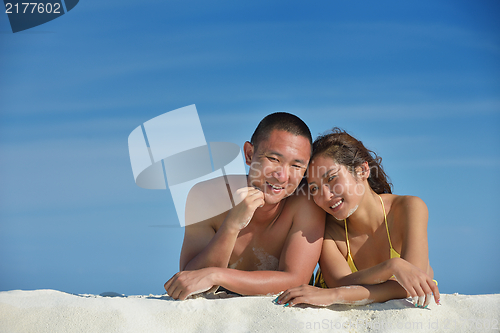 Image of happy young  couple enjoying summer on beach