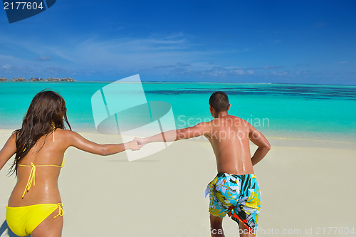 Image of happy young  couple enjoying summer on beach