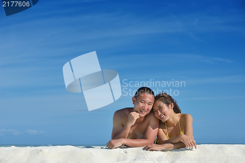 Image of happy young  couple enjoying summer on beach