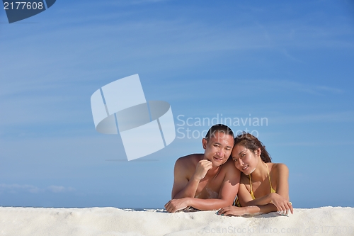 Image of happy young  couple enjoying summer on beach