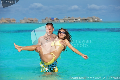 Image of happy young  couple enjoying summer on beach