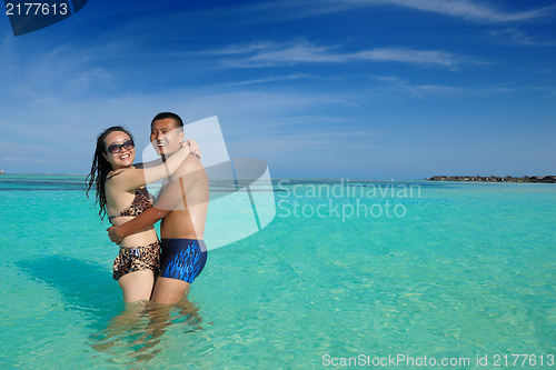 Image of happy young  couple enjoying summer on beach