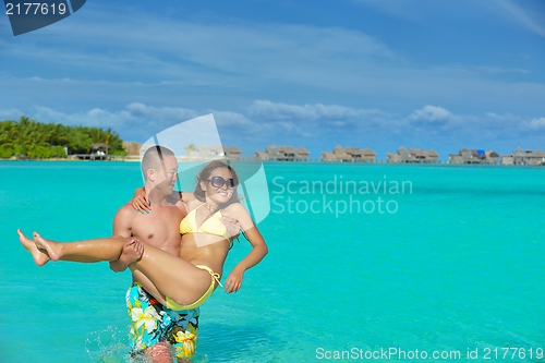 Image of happy young  couple enjoying summer on beach