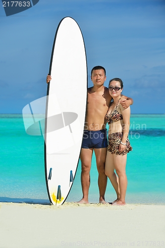 Image of happy young  couple enjoying summer on beach