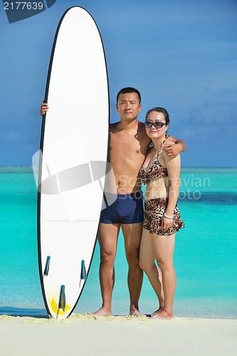 Image of happy young  couple enjoying summer on beach