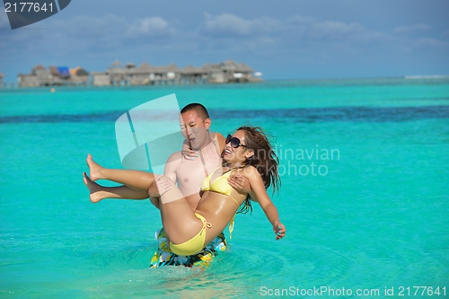 Image of happy young  couple enjoying summer on beach