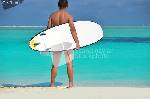 Image of Man with surf board on beach