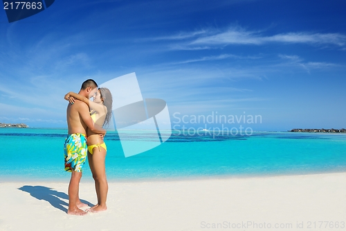 Image of happy young  couple enjoying summer on beach