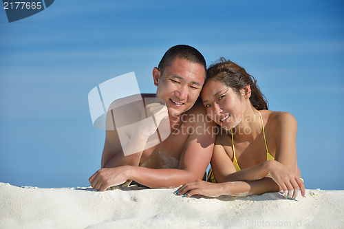 Image of happy young  couple enjoying summer on beach