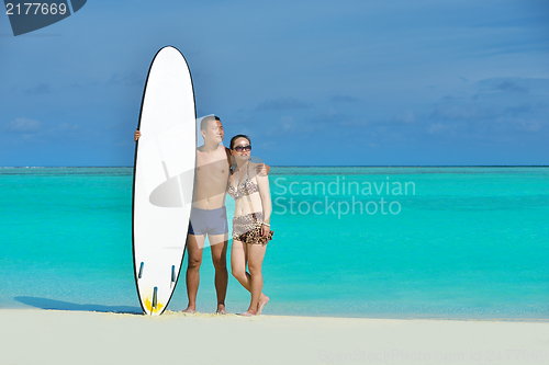 Image of happy young  couple enjoying summer on beach