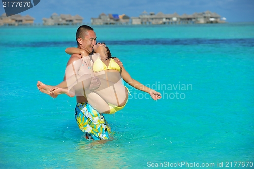 Image of happy young  couple enjoying summer on beach