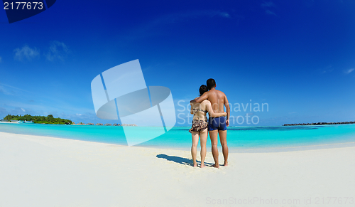 Image of happy young  couple enjoying summer on beach