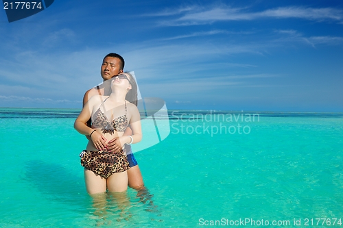 Image of happy young  couple enjoying summer on beach