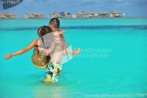 Image of happy young  couple enjoying summer on beach