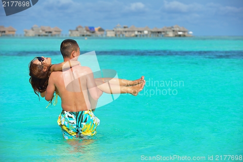 Image of happy young  couple enjoying summer on beach