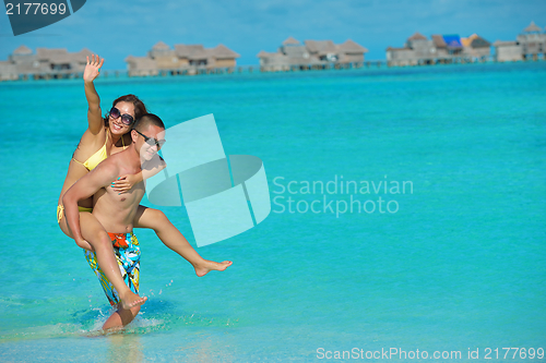 Image of happy young  couple enjoying summer on beach