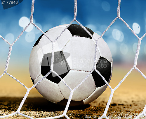 Image of ball on ground near goal-area