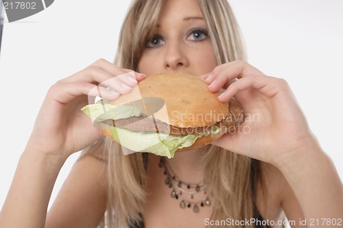 Image of Woman eating burger