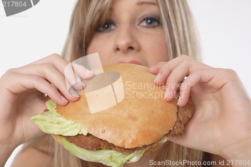 Image of Woman eating burger