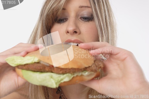 Image of Woman eating burger