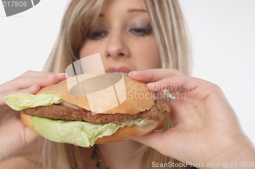 Image of Woman eating burger