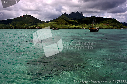 Image of tropical lagoon hill navigable     boat  and coastline in Deer I