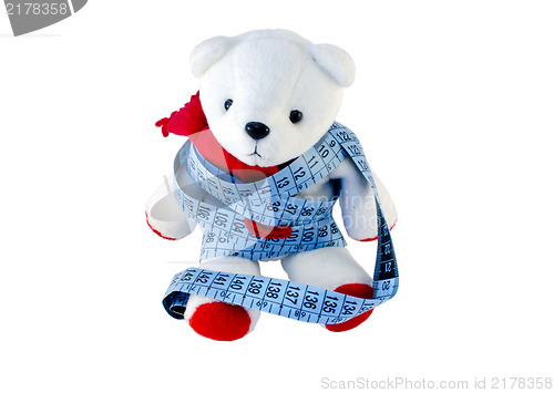 Image of small Teddy with red feet wrapped blue centimeter  
