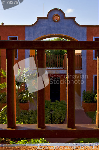 Image of  bush  window and red house  