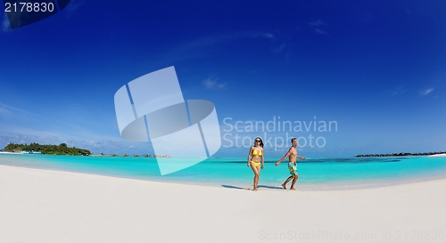 Image of happy young  couple enjoying summer on beach