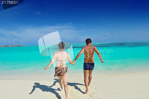 Image of happy young  couple enjoying summer on beach