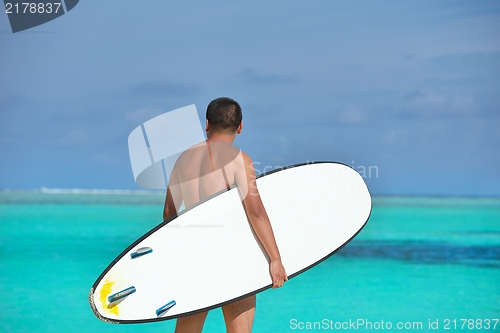 Image of Man with surf board on beach
