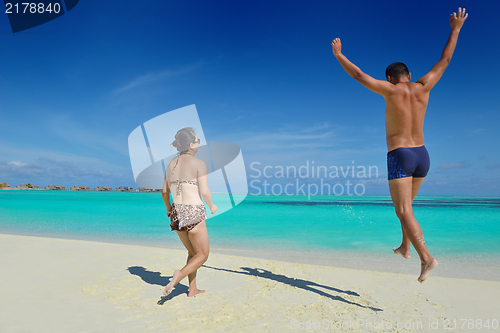 Image of happy young  couple enjoying summer on beach