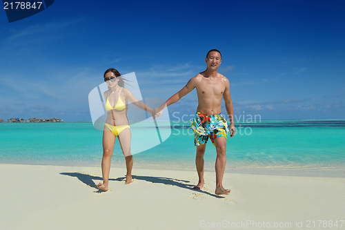 Image of happy young  couple enjoying summer on beach