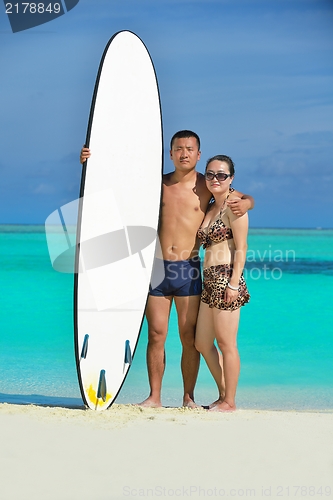 Image of happy young  couple enjoying summer on beach