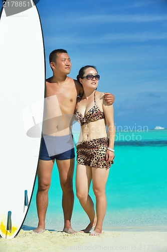 Image of happy young  couple enjoying summer on beach