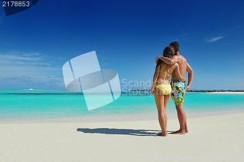 Image of happy young  couple enjoying summer on beach