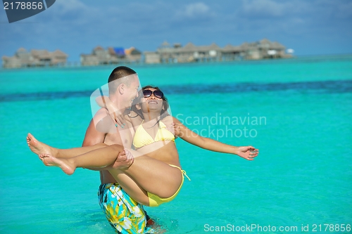 Image of happy young  couple enjoying summer on beach