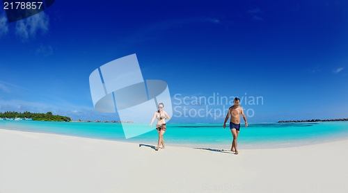 Image of happy young  couple enjoying summer on beach