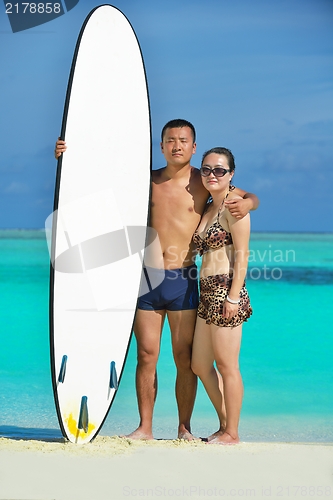Image of happy young  couple enjoying summer on beach