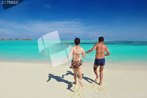 Image of happy young  couple enjoying summer on beach