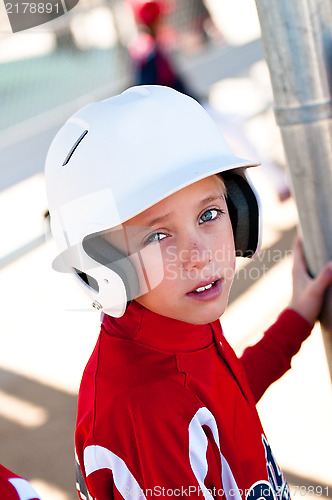 Image of Little league baseball player in dugout