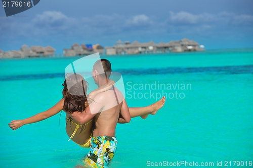Image of happy young  couple enjoying summer on beach