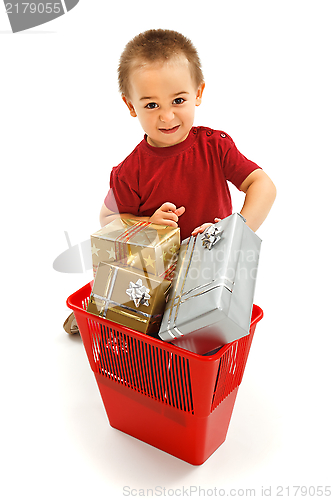 Image of Little boy throwing presents in garbage bin