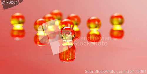 Image of Macro of E vitamine pills on red