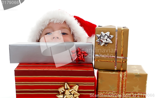 Image of Young boy peeking above gifts