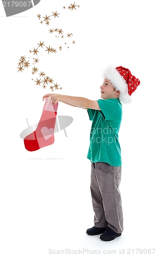 Image of Joyful child releasing stars from Christmas stocking