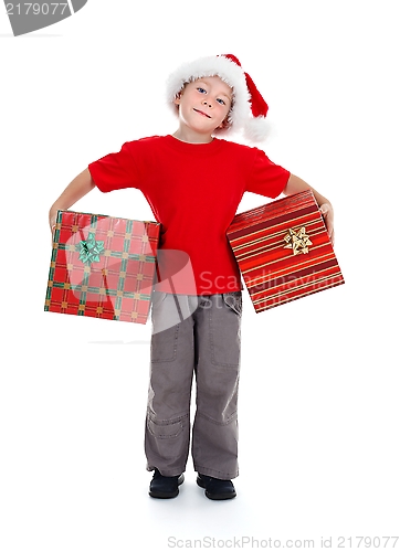Image of Young boy holding Christmas gifts