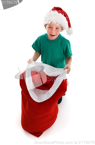 Image of Happy little boy holding open Santa sack