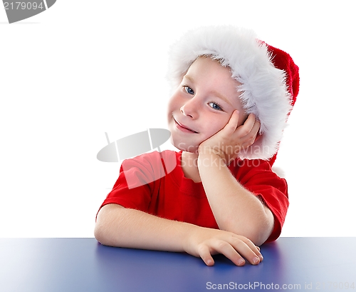 Image of Cute Christmas boy sitting at table